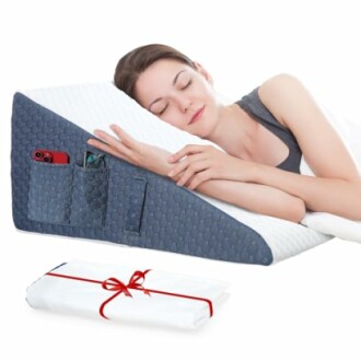 Woman sleeping on a wedge pillow with pockets holding a phone and glasses.